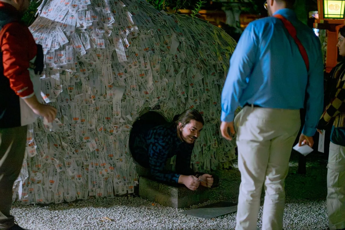 A guest crawling through the stone at Yasui Konpira-gu Shrine