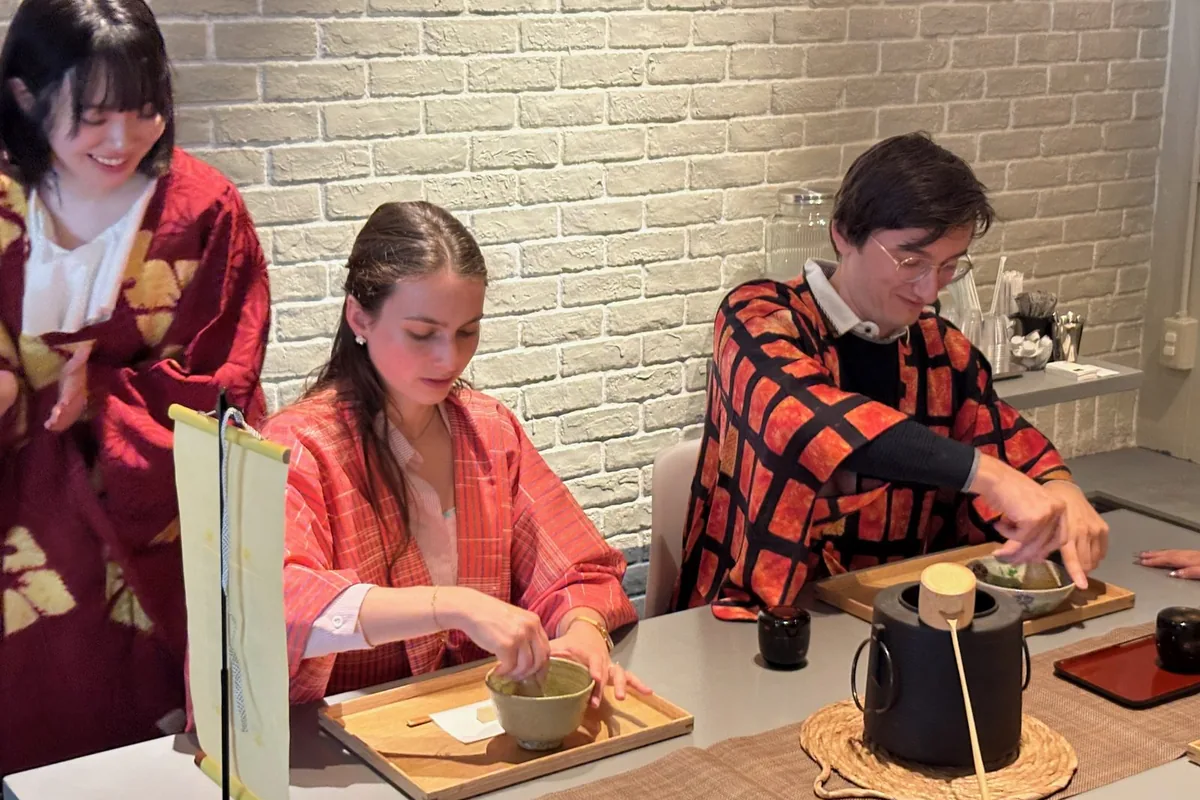 Guests in kimono whisking matcha